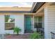 Inviting home exterior showcasing a blue front door, and nicely manicured desert landscaping at 821 E Harmony Ave, Mesa, AZ 85204