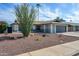 Inviting single-story home with a two car garage and desert landscaping with a brown gravel front yard at 821 E Harmony Ave, Mesa, AZ 85204