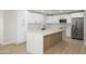Bright kitchen featuring white cabinets, gold hardware, stainless steel appliances, and a large island at 821 E Harmony Ave, Mesa, AZ 85204