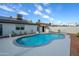 A private pool with cool blue water surrounded by lush landscaping and a concrete patio at 821 E Harmony Ave, Mesa, AZ 85204