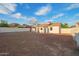 Backyard showcasing the rear of the house, enclosed by fencing, with plenty of potential for landscaping at 9042 N 3Rd Ave, Phoenix, AZ 85021