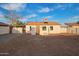 Backyard view of a single-story home with a gravel area, awning, and a door leading to the house at 9042 N 3Rd Ave, Phoenix, AZ 85021