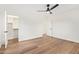 Bright bedroom with hardwood floors, ceiling fan, and walk in closet at 9042 N 3Rd Ave, Phoenix, AZ 85021