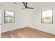 Bedroom features two windows, hardwood floors, and a ceiling fan at 9042 N 3Rd Ave, Phoenix, AZ 85021