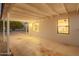 Covered parking area with white painted brick walls, modern lighting, and view of the kitchen through window at 9042 N 3Rd Ave, Phoenix, AZ 85021