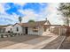 Attractive home with white painted brick, desert landscaping, long drive way, and covered parking area at 9042 N 3Rd Ave, Phoenix, AZ 85021