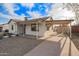 Attractive home with white painted brick, desert landscaping, long drive way, and covered parking area at 9042 N 3Rd Ave, Phoenix, AZ 85021