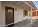 Inviting front porch with stylish wood door, white painted brick, and modern mailbox at 9042 N 3Rd Ave, Phoenix, AZ 85021