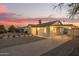 View of the property with white exterior, covered parking and desert landscaping at 9042 N 3Rd Ave, Phoenix, AZ 85021