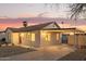 Exterior featuring a covered porch, attached covered carport and desert landscaping at 9042 N 3Rd Ave, Phoenix, AZ 85021
