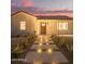 Home displaying its front entrance and walkway lighting surrounded by desert landscaping at 9042 N 3Rd Ave, Phoenix, AZ 85021