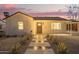 Charming house displaying its exterior lighting, carport, and desert-landscaped yard at 9042 N 3Rd Ave, Phoenix, AZ 85021