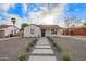 Inviting home featuring white painted brick, desert landscaping, and concrete walkway leading to the front door at 9042 N 3Rd Ave, Phoenix, AZ 85021