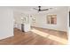 Bright, open living space with hardwood floors, black ceiling fan, and views into the kitchen and to the backyard at 9042 N 3Rd Ave, Phoenix, AZ 85021