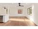 Spacious living area with hardwood floors, white walls, and views to the backyard through modern black-framed windows at 9042 N 3Rd Ave, Phoenix, AZ 85021