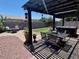 Outdoor living space featuring a pergola-covered patio, fire pit, and landscaped yard at 913 W Leadwood Ave, Queen Creek, AZ 85140