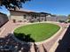 Spacious backyard with lush lawn, gravel, paver stones, and outdoor seating at 913 W Leadwood Ave, Queen Creek, AZ 85140