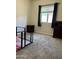 Empty bedroom with neutral carpet, a window with dark curtains, and dark wood furniture at 913 W Leadwood Ave, Queen Creek, AZ 85140