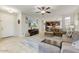 Spacious living room features tile flooring, modern furniture, and an open floor plan leading to the kitchen at 913 W Leadwood Ave, Queen Creek, AZ 85140