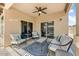 Outdoor patio featuring multiple seating areas, a ceiling fan, and beautiful decor at 913 W Leadwood Ave, Queen Creek, AZ 85140