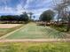 Hopscotch and volleyball area at community park with mature landscaping at 913 W Leadwood Ave, Queen Creek, AZ 85140