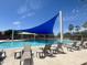 Community swimming pool area with ample seating and shade canopies at 913 W Leadwood Ave, Queen Creek, AZ 85140