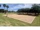 Sand volleyball court surrounded by lush green grass at the community park at 913 W Leadwood Ave, Queen Creek, AZ 85140