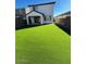 Backyard featuring artificial turf, a covered patio, and privacy fencing at 9444 W Roma Ave, Phoenix, AZ 85037