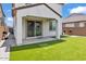 Tranquil backyard boasts artificial turf, a covered patio, and ample space for outdoor seating at 9444 W Roma Ave, Phoenix, AZ 85037