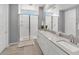 Beautiful bathroom with double sinks, spacious walk-in shower, and tile flooring at 9444 W Roma Ave, Phoenix, AZ 85037