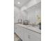 Bright bathroom featuring double sinks, light countertops, and a large mirror at 9444 W Roma Ave, Phoenix, AZ 85037