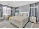 Cozy bedroom with a queen-size bed, decorative pillows, and neutral color palette at 9444 W Roma Ave, Phoenix, AZ 85037