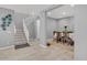 Inviting dining room showcases a wooden table and chairs, complemented by a staircase and neutral decor at 9444 W Roma Ave, Phoenix, AZ 85037