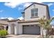 Inviting two-story home showcasing a gray garage door, covered front entry, and well-manicured landscaping at 9444 W Roma Ave, Phoenix, AZ 85037