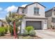 Charming two-story home with a gray garage door, stucco exterior, and manicured landscaping at 9444 W Roma Ave, Phoenix, AZ 85037