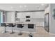 Sleek kitchen with a large island, modern stainless steel appliances, and ample cabinet space at 9444 W Roma Ave, Phoenix, AZ 85037