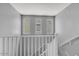 Staircase with a white banister leading to the upper level with neutral colored walls at 9444 W Roma Ave, Phoenix, AZ 85037