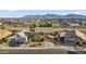 Wide aerial view of home showing its location within a neighborhood and views of distant mountains at 9719 W Heber Rd, Tolleson, AZ 85353