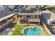Expansive backyard with pool, patio, grassy area, and solar panels on a two-story home in a suburban neighborhood at 9719 W Heber Rd, Tolleson, AZ 85353