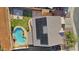 This aerial view highlights the home's pool, patio, solar panels, and landscaping at 9719 W Heber Rd, Tolleson, AZ 85353