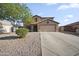 Charming two-story home featuring a two-car garage, desert landscaping, and inviting curb appeal at 9719 W Heber Rd, Tolleson, AZ 85353