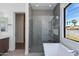 Spacious bathroom with a glass walk-in shower and adjacent bathtub at 100 W Northern Ave # 12, Phoenix, AZ 85021