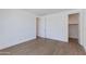 Bedroom with light wood floors and a walk-in closet and a neutral color palette at 100 W Northern Ave # 12, Phoenix, AZ 85021