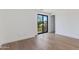 Bedroom featuring light wood flooring and sliding glass doors to a balcony area at 100 W Northern Ave # 12, Phoenix, AZ 85021