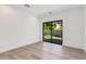 Bright bedroom with hardwood floors and sliding glass door to outdoor living at 100 W Northern Ave # 12, Phoenix, AZ 85021