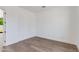 Empty bedroom with hardwood floors, light-colored walls, and a bright view outside at 100 W Northern Ave # 12, Phoenix, AZ 85021