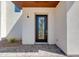 Elegant home entrance featuring a sleek glass door and stylish stone walkway and landscaped yard at 100 W Northern Ave # 12, Phoenix, AZ 85021
