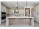 Modern kitchen featuring an island, stainless steel appliances, stylish backsplash, and pendant lighting at 100 W Northern Ave # 12, Phoenix, AZ 85021