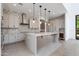 Modern kitchen with island, stainless steel appliances, stylish backsplash, and ample cabinet space at 100 W Northern Ave # 12, Phoenix, AZ 85021