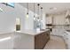 Contemporary kitchen boasts a center island, stainless appliances, and modern finishes and backyard access at 100 W Northern Ave # 12, Phoenix, AZ 85021